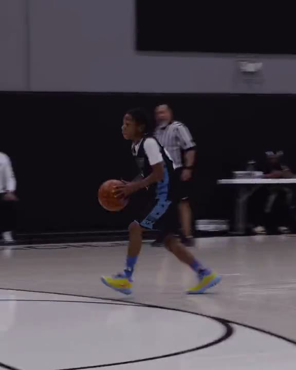 AZ Flight player driving the ball in a dark gym